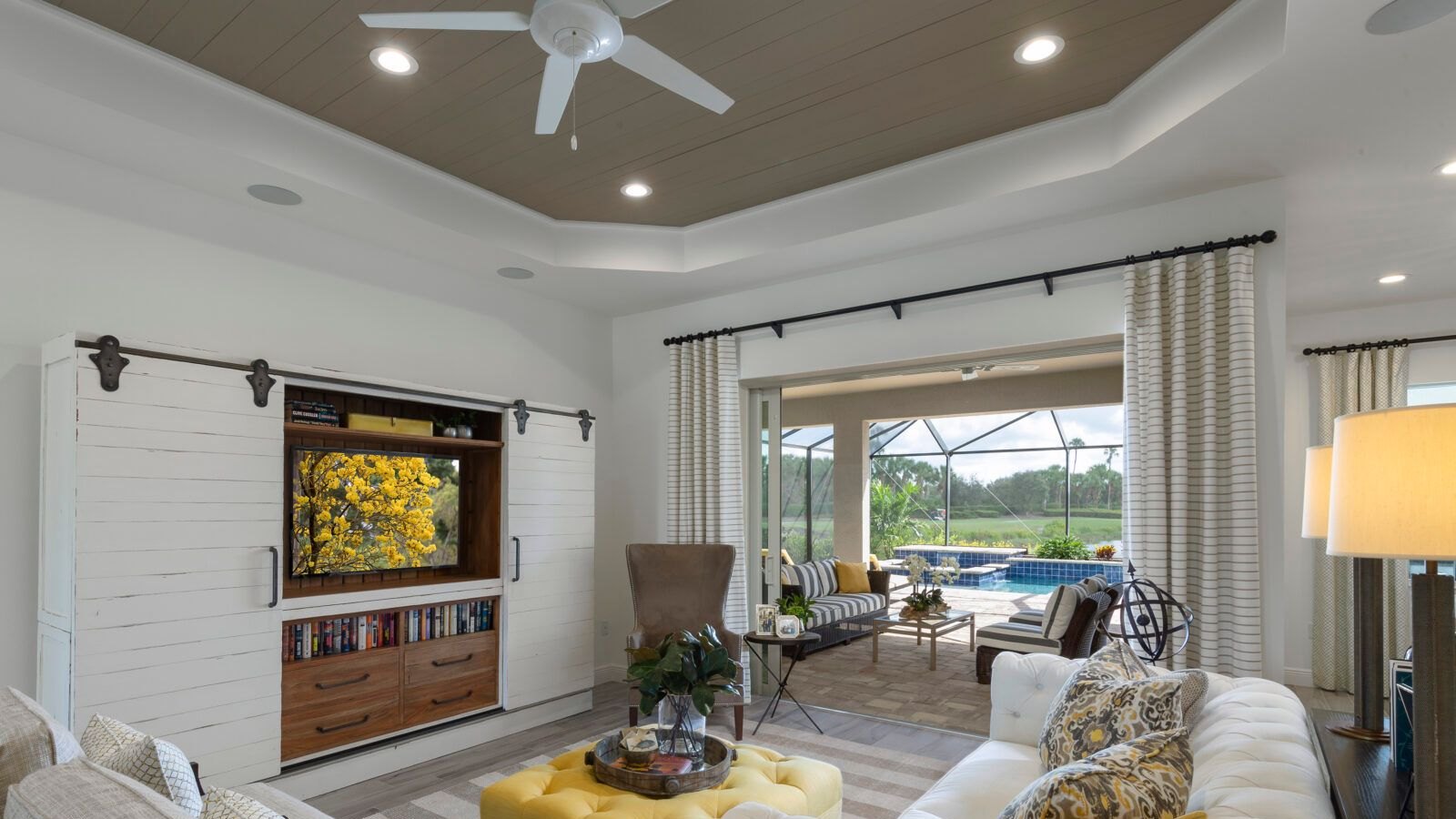 A bright great room opening onto a screened pool and lanai